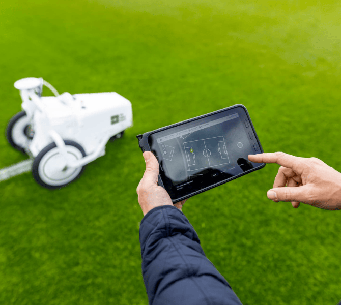 TinyLineMarker Pro X with tablet marking soccer field